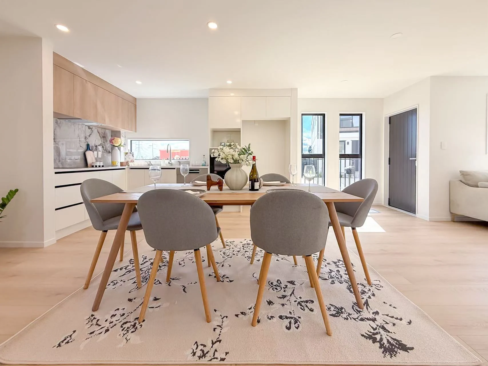 Furnished dining area beside a contemporary kitchen